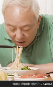 Close-up of a mature man having noodles