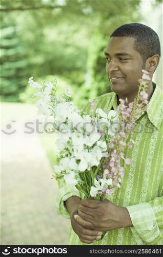 Close-up of a mature man holding a bunch of flowers