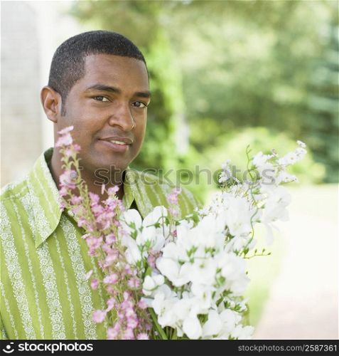 Close-up of a mature man holding a bunch of flowers