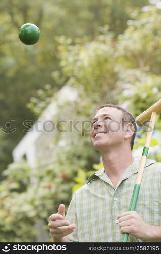 Close-up of a mature man holding a croquet mallet