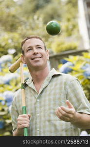 Close-up of a mature man holding a croquet mallet