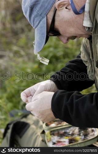 Close-up of a mature man holding a fishing bait