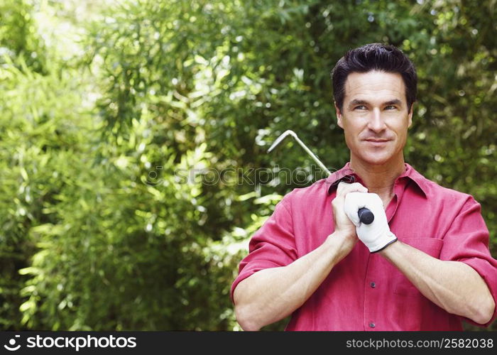 Close-up of a mature man holding a golf club