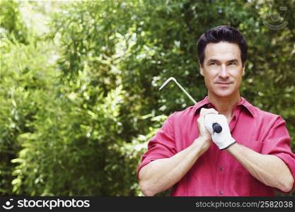 Close-up of a mature man holding a golf club