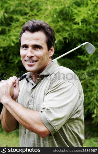 Close-up of a mature man holding a golf club