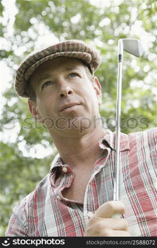 Close-up of a mature man holding a golf club
