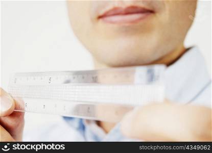 Close-up of a mature man holding a scale