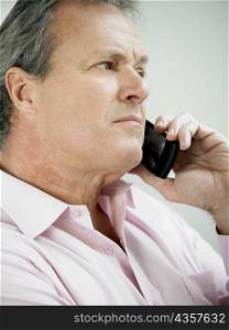 Close-up of a mature man holding on a mobile phone
