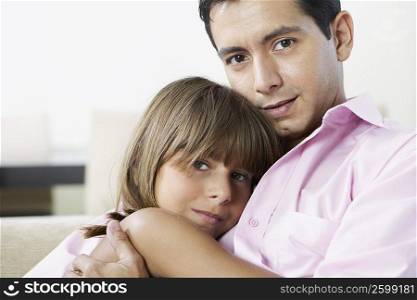 Close-up of a mature man hugging his daughter