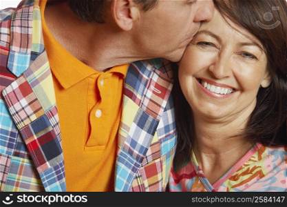 Close-up of a mature man kissing a mature woman