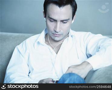 Close-up of a mature man listening to an MP3 player