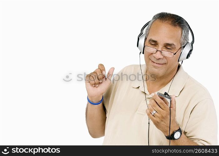 Close-up of a mature man listening to an MP3 player