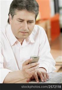 Close-up of a mature man looking at a mobile phone