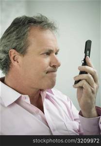 Close-up of a mature man looking at a mobile phone