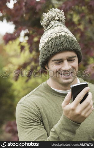 Close-up of a mature man looking at a mobile phone and smiling