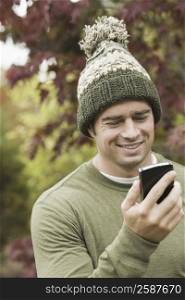 Close-up of a mature man looking at a mobile phone and smiling