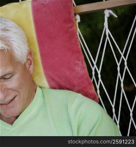 Close-up of a mature man lying in a hammock