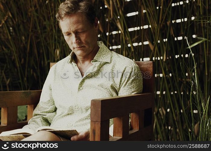 Close-up of a mature man reading a book