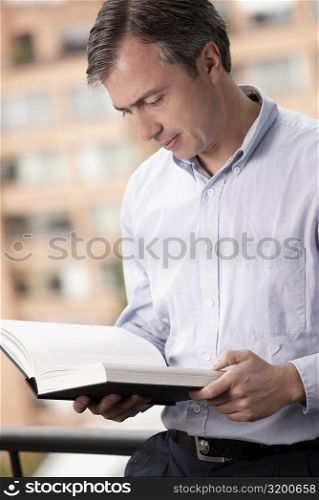 Close-up of a mature man reading a book