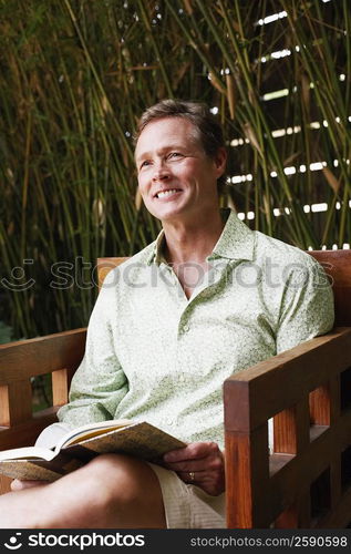 Close-up of a mature man sitting in an armchair and smiling