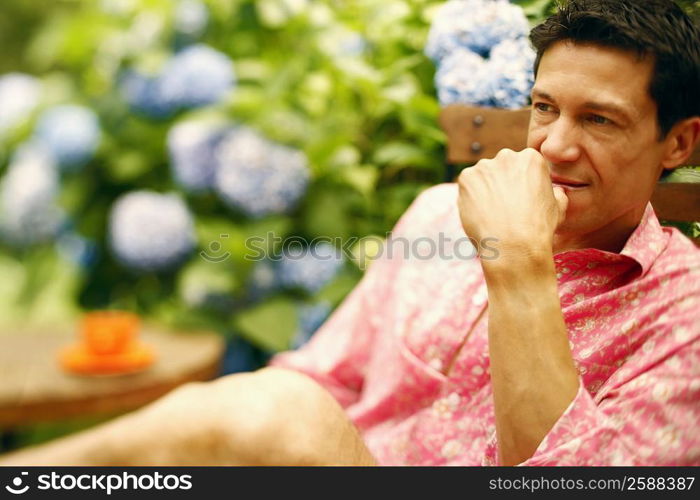 Close-up of a mature man sitting on a chair and thinking