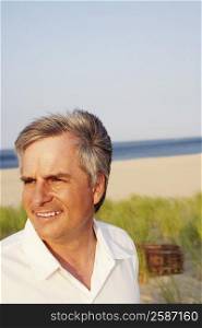 Close-up of a mature man smiling on the beach