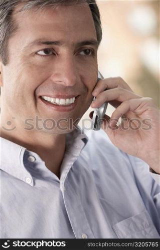 Close-up of a mature man talking on a mobile phone and smiling