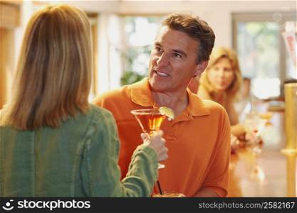 Close-up of a mature man talking to a woman in a bar