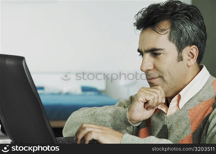 Close-up of a mature man using a laptop