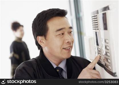 Close-up of a mature man using an intercom