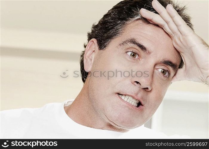 Close-up of a mature man with a headache
