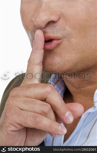 Close-up of a mature man with his finger on his lips