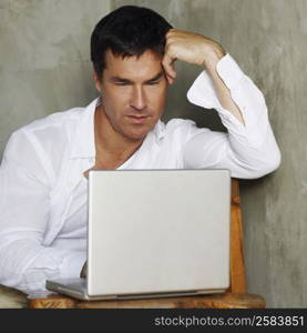 Close-up of a mature man working on a laptop