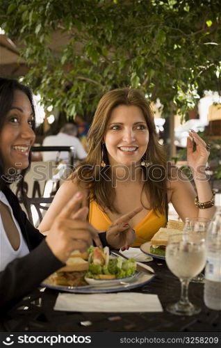 Close-up of a mature woman and a mid adult woman sitting in a restaurant, Santo Domingo, Dominican Republic