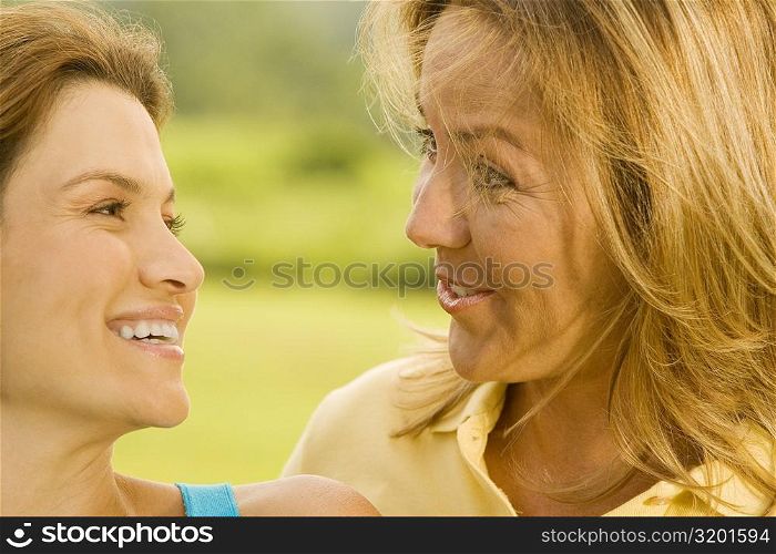 Close-up of a mature woman and a mid adult woman smiling