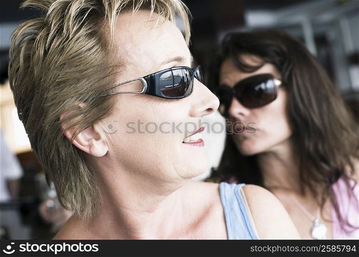 Close-up of a mature woman and a mid adult woman wearing sunglasses