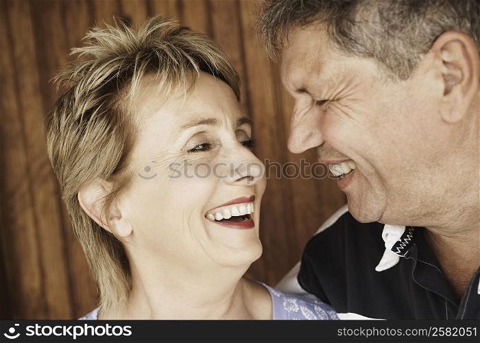 Close-up of a mature woman and a senior man looking at each other