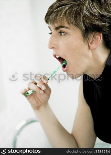 Close-up of a mature woman brushing her teeth
