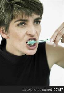 Close-up of a mature woman brushing her teeth