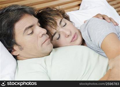 Close-up of a mature woman embracing a mature man on the bed