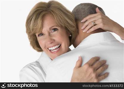Close-up of a mature woman embracing a senior man