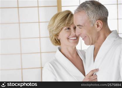 Close-up of a mature woman embracing a senior man and smiling