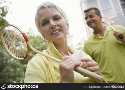 Close-up of a mature woman holding a badminton racket and a shuttlecock