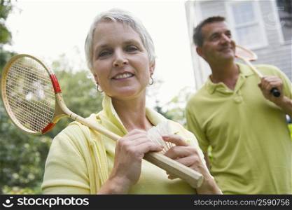 Close-up of a mature woman holding a badminton racket and a shuttlecock