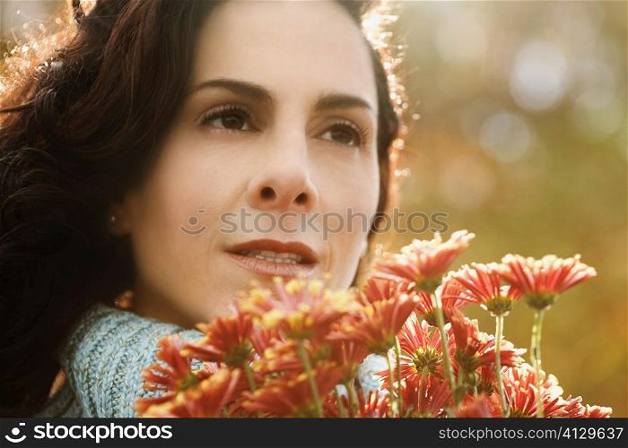 Close-up of a mature woman holding a bunch of flowers