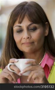 Close-up of a mature woman holding a coffee cup