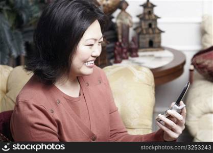Close-up of a mature woman holding a mobile phone