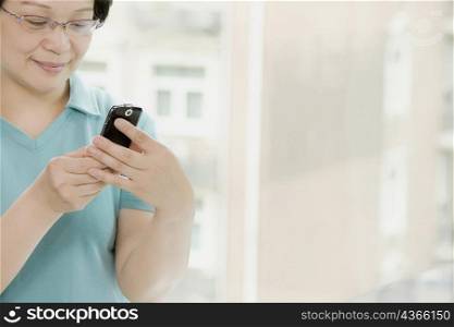 Close-up of a mature woman holding a mobile phone