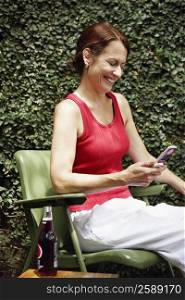 Close-up of a mature woman holding a mobile phone and smiling