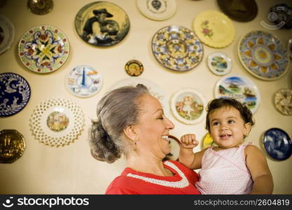 Close-up of a mature woman holding her granddaughter